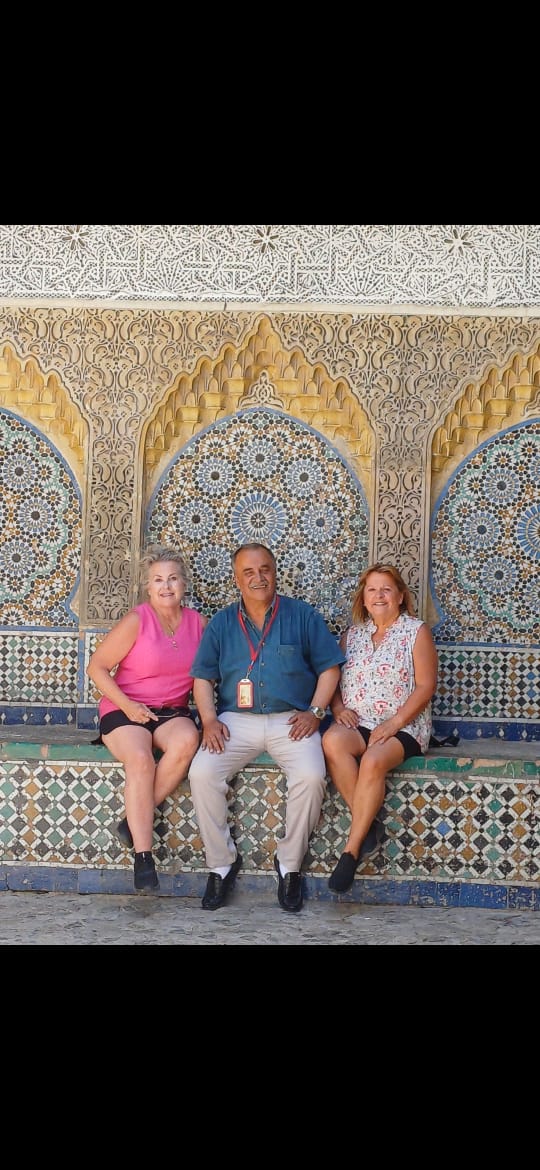 Guests admiring intricate Moroccan tile work